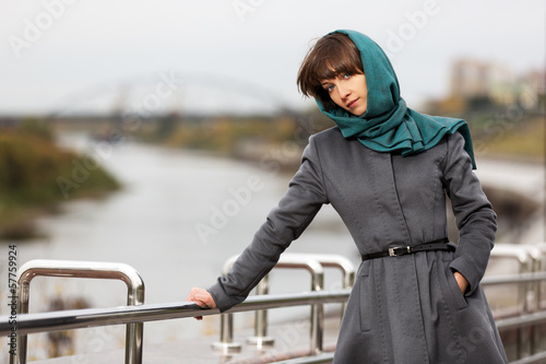 Photo: Sad young woman in grey classic coat Sad young woman in grey classic coat