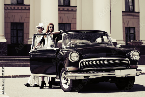 Photo: Young couple at the retro car Young couple at the retro car