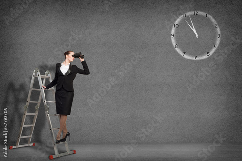 Photo: businesswoman looking through binoculars businesswoman looking through binoculars