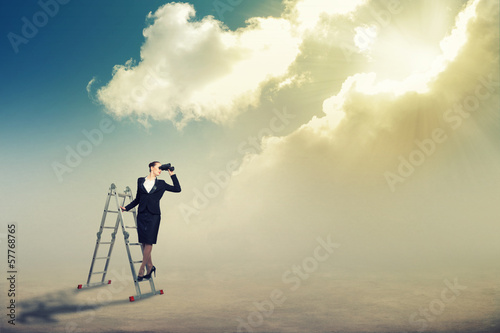 Photo: businesswoman looking through binoculars businesswoman looking through binoculars