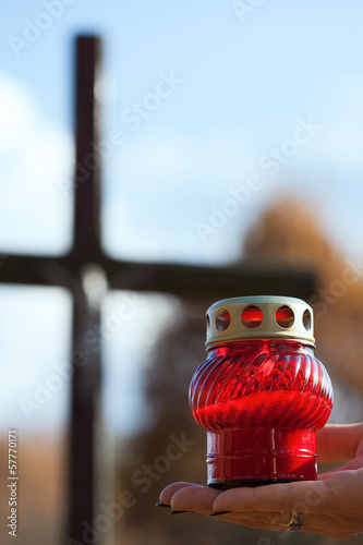 Photo: Holding a candle at cemetery Holding a candle at cemetery