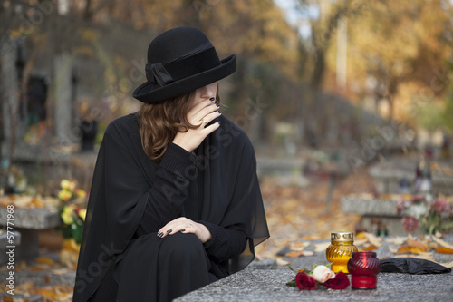 Photo: Grieving woman at graveyard Grieving woman at graveyard
