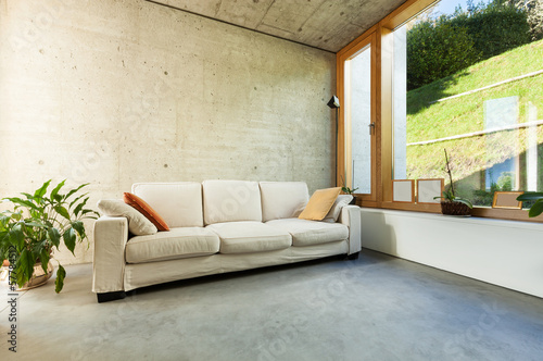 Photo: beautiful modern house in cement, interiors, room with divan beautiful modern house in cement, interiors, room with divan