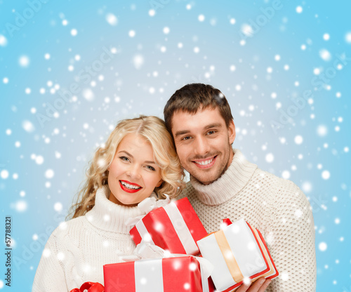 Photo: smiling woman and man with gift box smiling woman and man with gift box