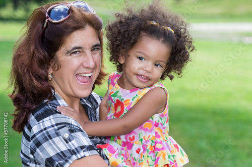 Photo: Hispanic woman hugging a small girl outdoors Hispanic woman hugging a small girl outdoors