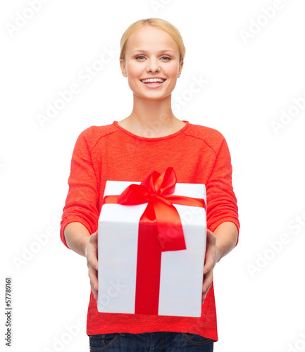 Photo: smiling woman in red sweater with gift box smiling woman in red sweater with gift box