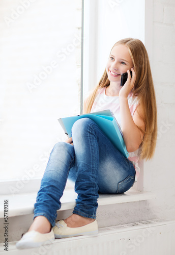 Photo: girl with smartphone at school girl with smartphone at school