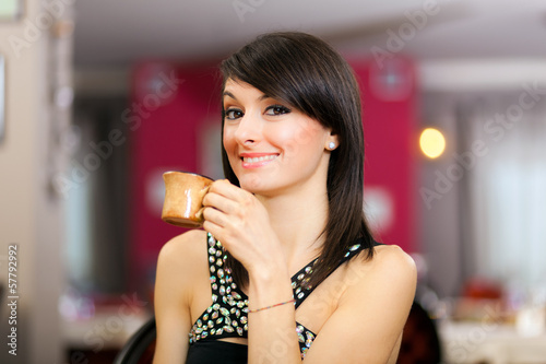 Photo: Woman drinking coffee at the restaurant Woman drinking coffee at the restaurant