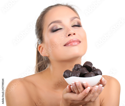 Photo: Portrait of beautiful young girl with chocolate candies Portrait of beautiful young girl with chocolate candies