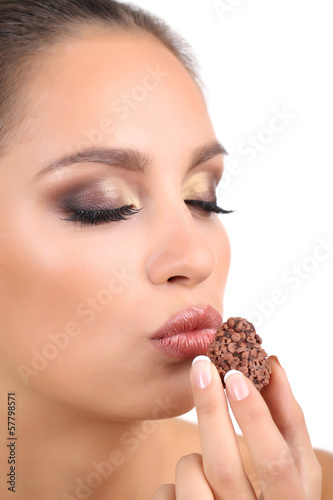 Photo: Portrait of beautiful young girl with chocolate candy isolated Portrait of beautiful young girl with chocolate candy isolated