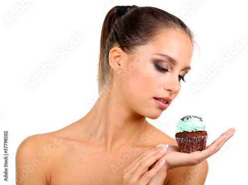 Photo: Portrait of beautiful young girl with chocolate cupcake Portrait of beautiful young girl with chocolate cupcake