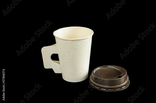 Photo: Paper coffee cup with isolated black background Paper coffee cup with isolated black background