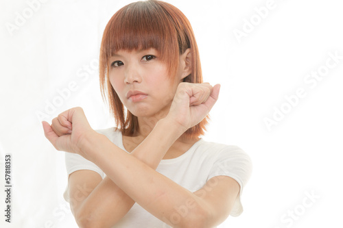 Photo: bright picture of young Asian woman making stop gesture bright picture of young Asian woman making stop gesture