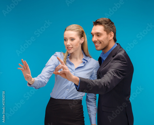 Photo: woman and man working with virtual screen woman and man working with virtual screen