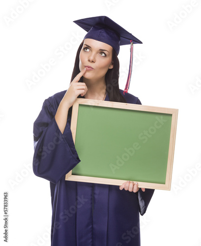 Photo: Thinking Female Graduate in Cap and Gown Holding Blank Chalkboar Thinking Female Graduate in Cap and Gown Holding Blank Chalkboar