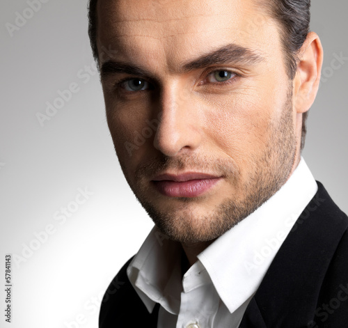 Photo: Closeup face of a fashion businessman in suit Closeup face of a fashion businessman in suit