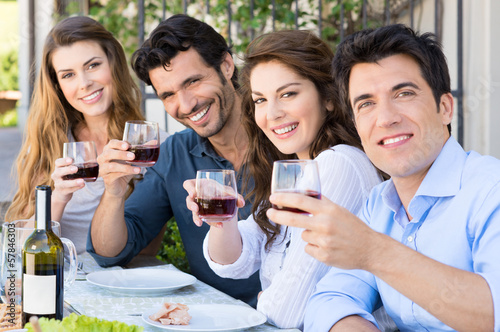 Photo: Friends Cheering With Wine Glasses Friends Cheering With Wine Glasses