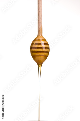 Photo: honey is dripping from the spoon honey is dripping from the spoon