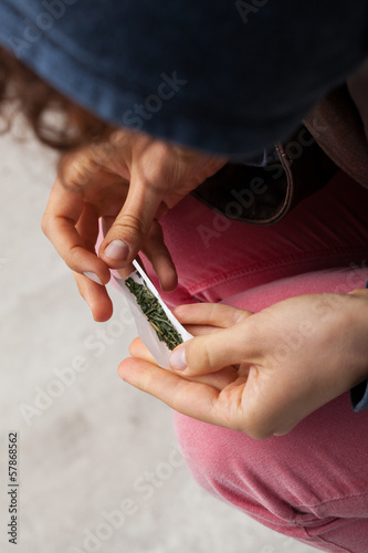 Photo: Girl rolling a joint Girl rolling a joint