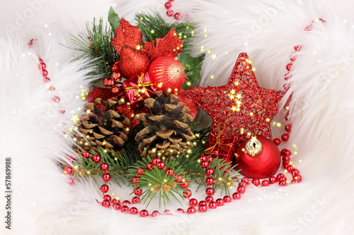 Photo: Christmas gift and red christmas balls in white fur Christmas gift and red christmas balls in white fur