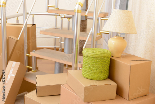 Photo: Stack of cartons near stairs: moving house concept Stack of cartons near stairs: moving house concept