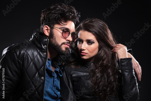 Photo: pensive man with glasses and long beard embracing his girlfriend pensive man with glasses and long beard embracing his girlfriend