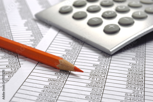 Photo: financial calculation with red pencil financial calculation with red pencil