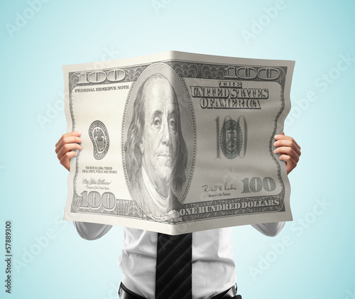 Photo: businessman reading magazine dollar businessman reading magazine dollar
