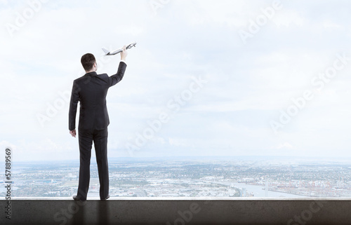 Photo: man holding airplane man holding airplane