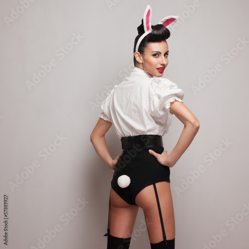 Photo: Pinup styling girl posing in vintage bunny costume Pinup styling girl posing in vintage bunny costume