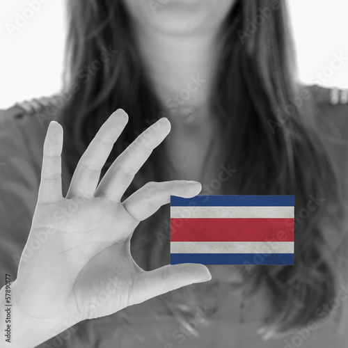 Photo: Woman showing a business card Woman showing a business card