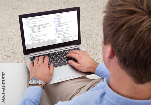 Photo: Man Using Laptop Man Using Laptop