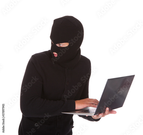 Photo: Burglar Using Laptop Burglar Using Laptop