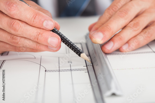 Photo: Architect Drawing On Blueprint Architect Drawing On Blueprint