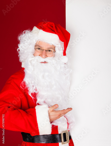 Photo: Portrait of a santa holding blank placard Portrait of a santa holding blank placard