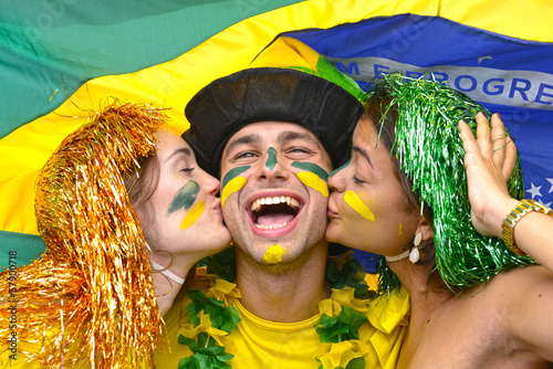 Photo: Brazilian soccer fans celebrating victory kissing each other. Brazilian soccer fans celebrating victory kissing each other.
