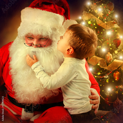 Photo: Santa Claus and Little Boy. Christmas Scene Santa Claus and Little Boy. Christmas Scene