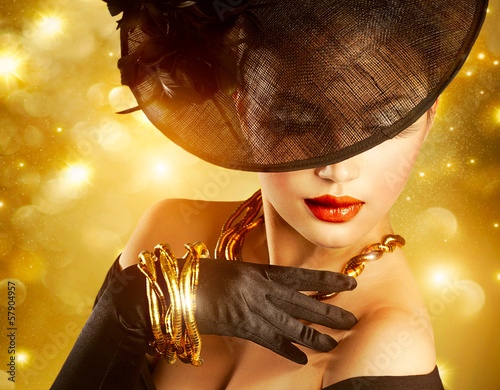Photo: Luxurious Woman over Holiday Golden Background Luxurious Woman over Holiday Golden Background