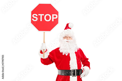 Photo: Smiling Santa Claus holding a stop sign Smiling Santa Claus holding a stop sign