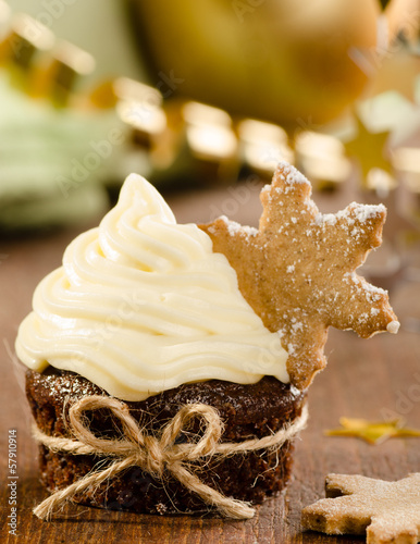 Photo: Christmas cupcake with snow flake cookie on top with christmas d Christmas cupcake with snow flake cookie on top with christmas d