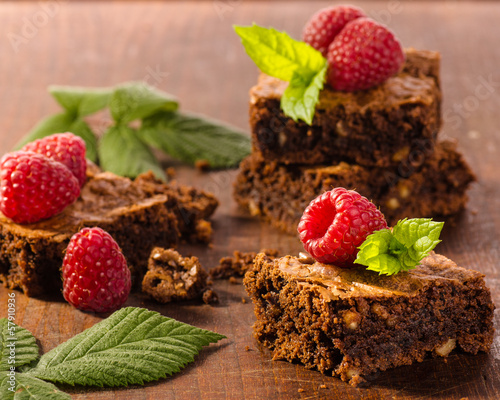 Photo: Chocolate brownies with raspberries on wooden background Chocolate brownies with raspberries on wooden background