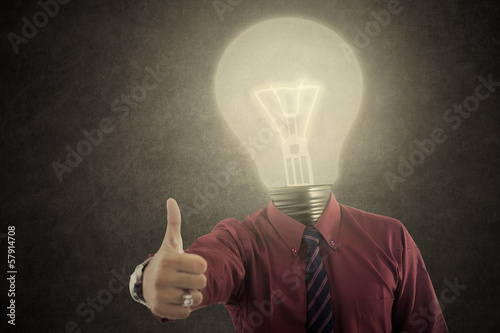 Photo: Businessman with lamp-head shows OK Businessman with lamp-head shows OK