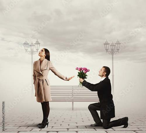 Photo: woman rejecting man with flowers woman rejecting man with flowers