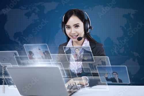 Photo: Happy businesswoman with pictures interface Happy businesswoman with pictures interface