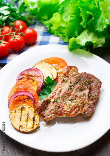 Photo: Steak with grilled vegetables on a plate Steak with grilled vegetables on a plate