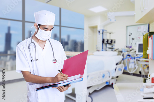 Photo: Male doctor making notes Male doctor making notes