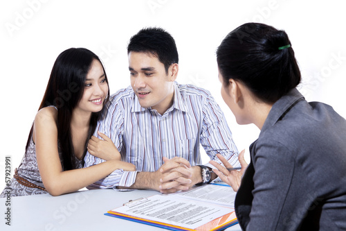 Photo: Young couple meeting financial consultant Young couple meeting financial consultant