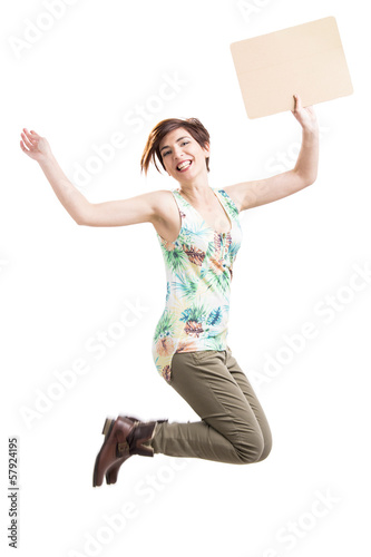 Photo: Beautiful woman jumping and holding a cardboard Beautiful woman jumping and holding a cardboard