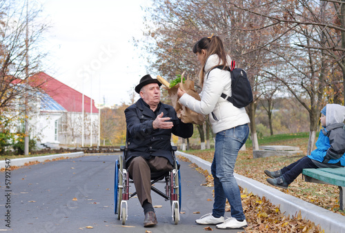 Photo: Mother helping her elderly disabled father Mother helping her elderly disabled father