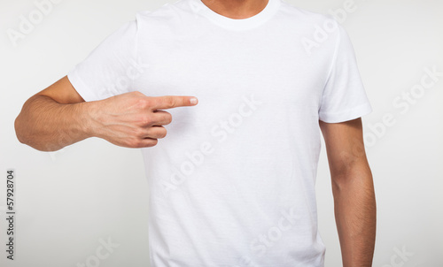 Photo: Man pointing his finger on a blank t-shirt Man pointing his finger on a blank t-shirt